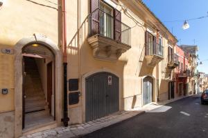 a building with a door on the side of a street at Ragusa 59 in Ragusa