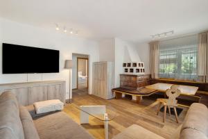 a living room with a couch and a flat screen tv at Premium App Hofer Sandra in Villabassa