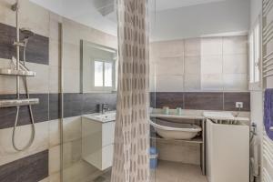 a bathroom with a shower and a sink and a tub at Le Relax 41 in Saint-Aignan +20 photos