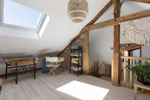 an attic room with a desk and a window at Gîte Bricabroc 2 adultes 2 enfants in Noyant +17 photos