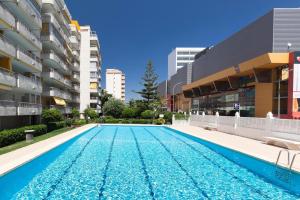 a swimming pool in the middle of a building at Atico Playa Gandia in Playa de Gandia