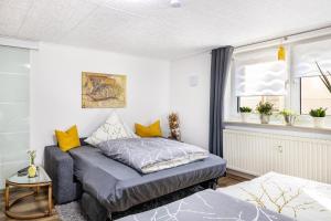 a bedroom with a bed and a window at Angie's Ferienapartment in Lichtenfels +26 photos