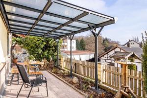 a pergola on a patio with a table and chairs at Angie's Ferienapartment in Lichtenfels