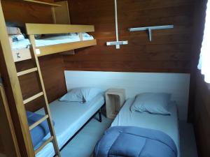 two bunk beds in a room with a ladder at Chalet bois 7 Domaine Les Epinettes in Saint-Gervais +13 photos
