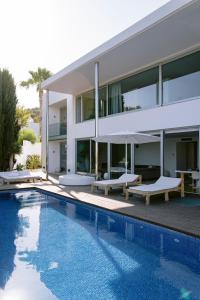 a house with a swimming pool next to a building at Villa 10 9 in Sant Josep