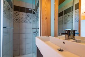 a bathroom with a sink and a shower at Cabane Ecolodge La Chastanha in Saint-Symphorien-de-Mahun