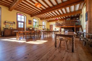 a large room with wooden tables and chairs at Cabane Ecolodge La Chastanha in Saint-Symphorien-de-Mahun