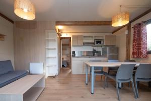 a kitchen and dining room with a table and chairs at Chalet 35m2 - Molène in Plouhinec