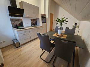 a dining room table and chairs in a kitchen at Haus Herdi-Schön in Herdwangen-Schönach