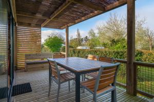 a patio with a table and chairs on a deck at Chalet 35m2 - Molène in Plouhinec