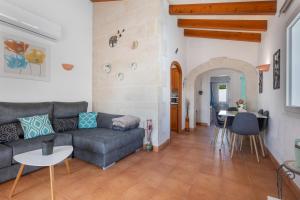 a living room with a couch and a table at Villa Rose in Cala Blanca