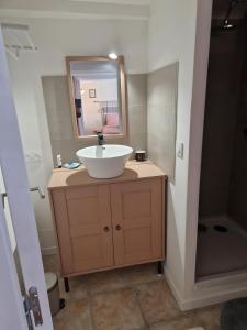a bathroom with a sink and a mirror at La Farigoulette in Aniane
