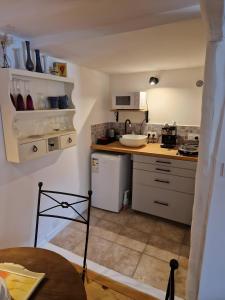 a kitchen with a sink and a counter top at La Farigoulette in Aniane +3 photos