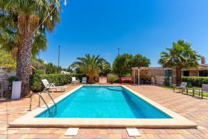 a swimming pool in a yard with palm trees at Villa Relax Due in Galatone