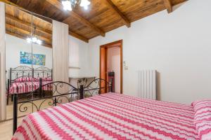 a bedroom with a bed with a red and white blanket at Villa Relax Due in Galatone +37 photos