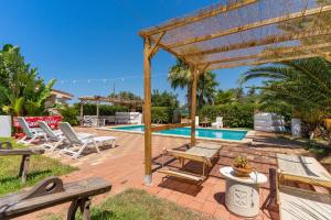 a patio with a wooden pergola and a swimming pool at Villa Relax Due in Galatone