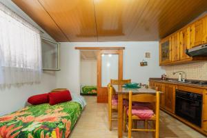 a kitchen with a table and a bed in a room at Villa Relax Due in Galatone