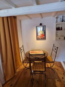 a table and two chairs in a room at La Farigoulette in Aniane