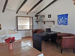 a living room with a desk with a laptop on it at Casa ricapaz - Long Term Advantage in Castillo de Locubín