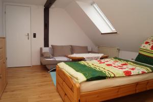 a bedroom with a bed and a couch and a window at Alte Schule in Bad Wildungen