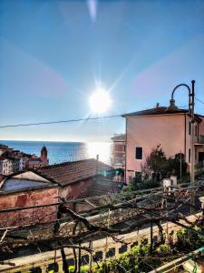 a view of a city with the ocean in the background at Terrazza nel Vigneto - Free parking in Tellaro