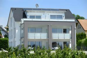 a large white house with a balcony at Dinkelbach Traumblick 3 C in Hengnau