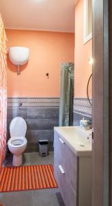 a bathroom with a toilet and a sink at Casa Monet 90 wifi-parking in Capodimonte +8 photos