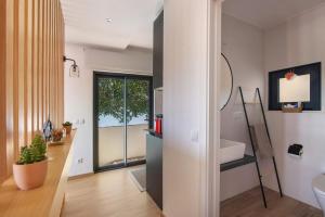 a bathroom with a sink and a mirror at Tiny House in São Brás de Alportel