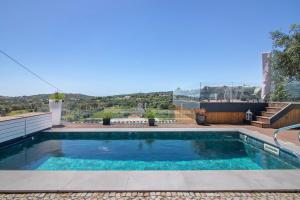 a swimming pool on the roof of a house at Tiny House in São Brás de Alportel