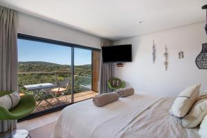 a bedroom with a large bed and a balcony at Tiny House in São Brás de Alportel +19 photos