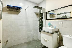 a bathroom with a shower and a sink and a toilet at El Rinconcito del Faro in Gáldar +14 photos