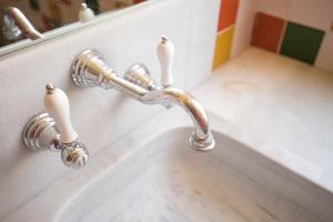 a bathroom sink with a chrome faucet at Villa Republica Argentina in Ciutadella +17 photos