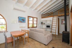 a living room with a couch and a table at Villa Republica Argentina in Ciutadella