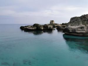 a large body of water with rocks in the water at Ruralholidays in Calimera +24 photos
