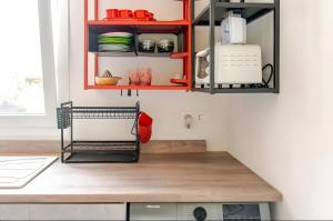 a kitchen with red cabinets and a counter top at Ruralholidays in Calimera
