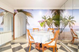 a dining room with a table and a view of the ocean at Cas Momio in Palma de Mallorca