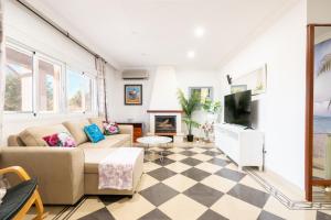 a living room with a couch and a tv at Cas Momio in Palma de Mallorca