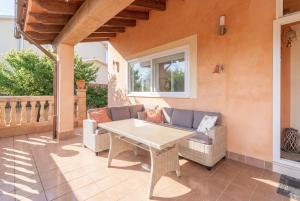 a patio with a table and chairs on a porch at Cas Momio in Palma de Mallorca
