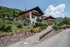 a house on a stone wall next to a road at Appartements Gabrielli Marie in Trodena