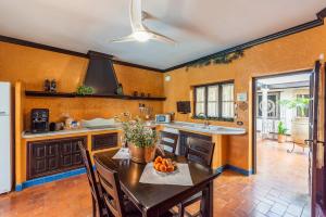 a kitchen with a table with a bowl of fruit on it at Casa Rural La Teja in Marchena