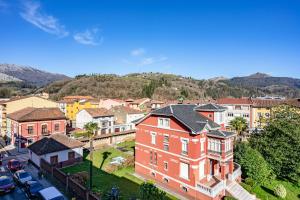 an aerial view of a town with a red house at Comarca del Sella in Arriondas
