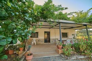 a patio of a house with trees and plants at Huerta del Sol in Aracena