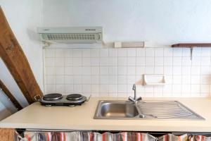 a kitchen counter with a sink and a stove at Studio Tamburine Xaharra in Ainhoa