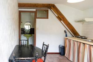 a dining room with a table and a kitchen at Studio Tamburine Xaharra in Ainhoa +8 photos