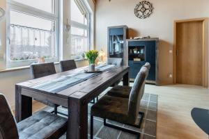 a dining room with a wooden table and chairs at Ferienwohnung Auf dem Hohen in Hüfingen