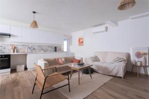 a living room with a couch and a table at Bel appartement 3 piece in Saint-Hippolyte