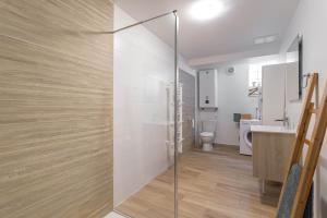 a bathroom with a glass shower and a toilet at Bel appartement 3 piece in Saint-Hippolyte +16 photos