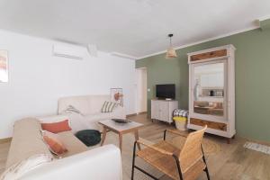 a living room with a couch and a table at Bel appartement 3 piece in Saint-Hippolyte