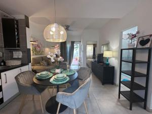 a kitchen and living room with a table and chairs at Bungalow Aloe Dunas in Maspalomas
