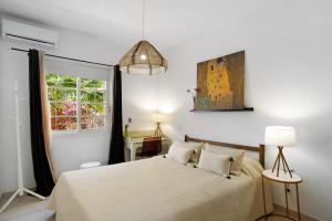 a bedroom with a bed and a window at Bungalow Aloe Dunas in Maspalomas +13 photos